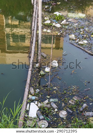 pollution problems, thailand townhouse building and garbage in reflection canal, river