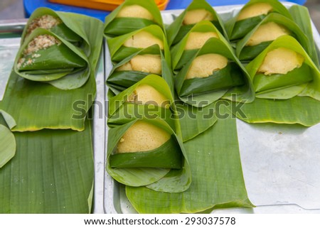 thai dessert - Sticky rice custard wrapped in banana leaf at thai street market, bangkok,thailand
