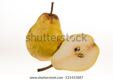 Whole and cut pears on a white background