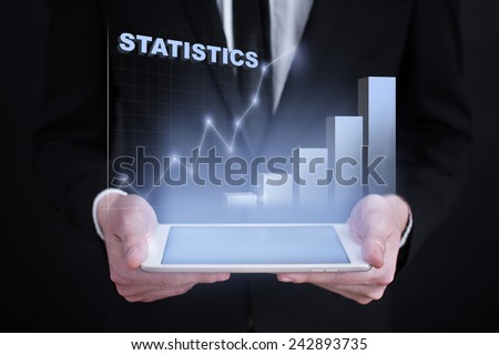 businessman holding a tablet PC with the projection of statistics graph. investment concept.  financial growth. char. data analysis. statistics