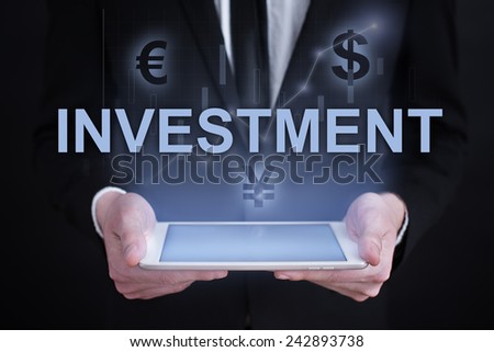 businessman holding a tablet PC with the projection of  investment conceptand graphs of financial growth financial growth. char. data analysis. statistics