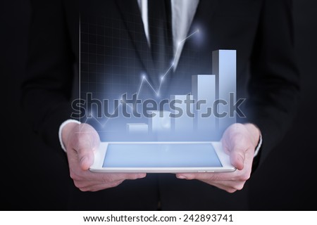 businessman holding a tablet PC with the projection of graph. investment concept.  financial growth. char. data analysis. statistics