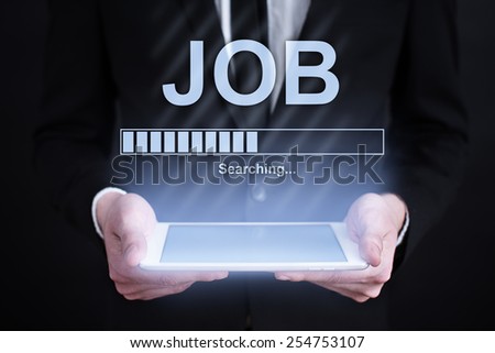 businessman holding a tablet with job searching bar  on the screen. Internet concept. business concept.