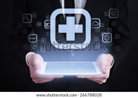 Businessman holding a mobile phone with medical app icon on virtual screen. Internet concept. medical concept.