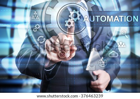 Businessman using modern computer, pressing automation icon on virtual screen. Business strategy. business, technology and internet concept.