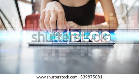 Woman using tablet pc and selecting blog.
