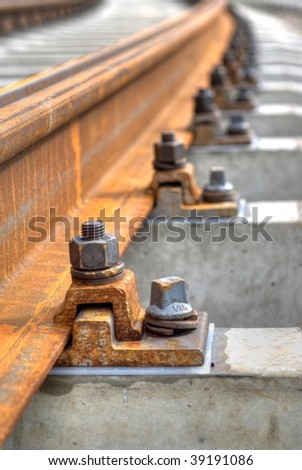 close up of trolley tracks. Focus on first bolt.  Shallow depth of field