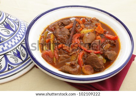 A moroccan beef tagine served in the traditional tagine dish. The casserole uses beef, onion, carrots, capsicums, a cinnamon stick and a traditional mix of spices known as ras el hanout