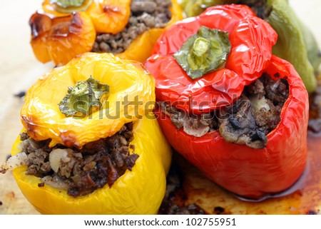 Colourful bell peppers or capsicums stuffed with a filling of ground beef, mushroom, onion and celery, straight from the oven.