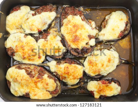 Top view of the Greek dish of aubergines stuffed with minced beef, onion and tomatoes, topped with bechamel sauce and cheese, fresh from the oven.