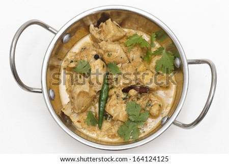 Homemade balti chicken pasanda, made with spices, yoghurt, cream and chopped coriander and chillies seen from above in a kadai ( karahi or wok) serving bowl, garnished with cilantro and a green chilli