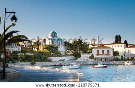 Spetses Town promenade on the Aegean island of Spetses, Greece, showing the old Monastery of Agios Nikolaos which is now the island\'s cathedral.