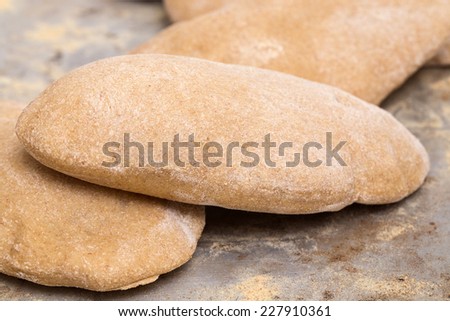 Loaves of traditional Egyptian homemade brown pita bread, fresh from the oven, called aish baladi
