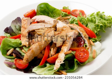 Warm chicken and mushroom salad, with  lettuce, cherry tomatoes, pine-nuts and strips of pepper