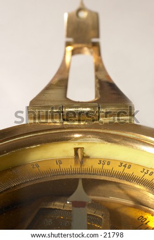 Old brass compass with it\'s needle pointing north. Symbolising the right course.