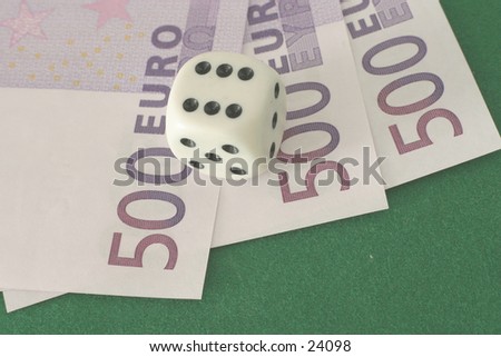 High roller: a die showing six on three high-value euro notes.