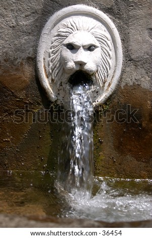 Natural spring water in the mountain village of Spili, Crete, gushes from a lion\'s mouths in the village square.