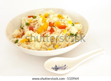A bowl of vegetable fried rice, with a spoon