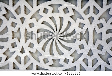 An example of Islamic design cast in concrete on a building in Doha, Qatar, crudely painted white. As Islam bans the depiction of human or animal forms, artists developed their style using shapes.