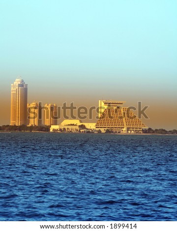 The Doha Sheraton Hotel pyramid and the Four Seasons Hotel towers with the Conference Centre between them, viewed from the Cornice in Doha, Qatar.