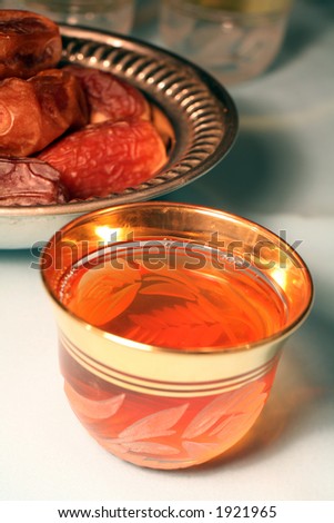 A traditional welcome or Ramadan fast-breaking iftar snack of sweet tea and dates, typical of Arabia