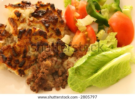 Shepherd\'s pie and salad, traditional British home-cooking.