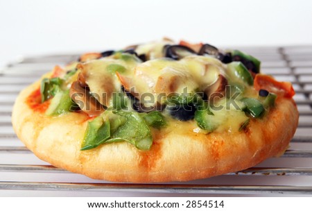 An individual-size pizza on a cooling rack - an ideal quick snack