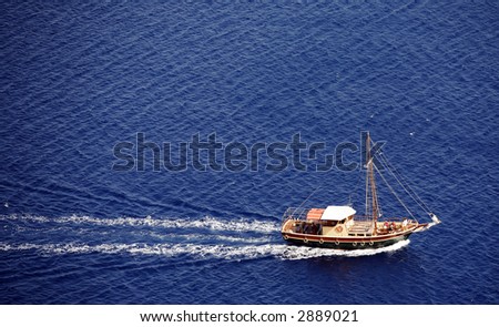 Aerial view of a small yacht cruising in the Mediterranean