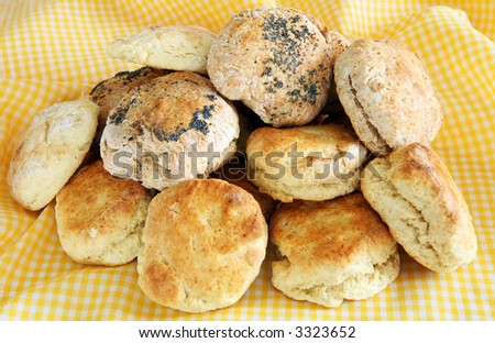 An assortment of home-made breads and scones on a gingham table cloth.