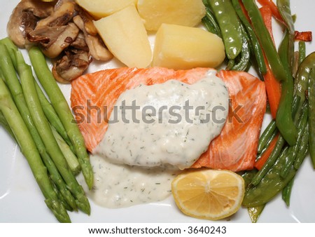 Grilled salmon steak with asparagus, fried mushrooms, stir-fried veg, boiled potatoes and a lemon wedge.