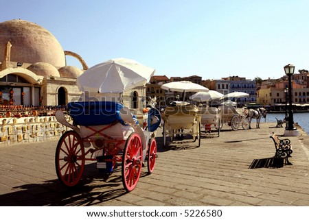 Horse-drawn taxis drawn up awaiting customers for pleasure trips around the old part of Hania, Crete.