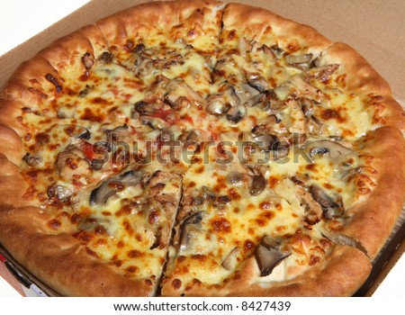 A whole cheese, mushroom and meat pizza in a cardboard delivery box.