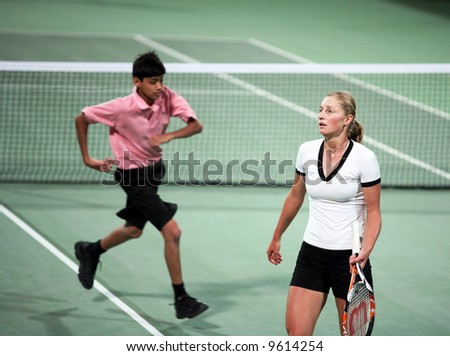 Qualifier Ekaterina Makarova    feels the pressure during her match with fellow Russian Maria Kirilenko at the Qatar Total Open, February 18, 2008, while a ball boy passes behind her.