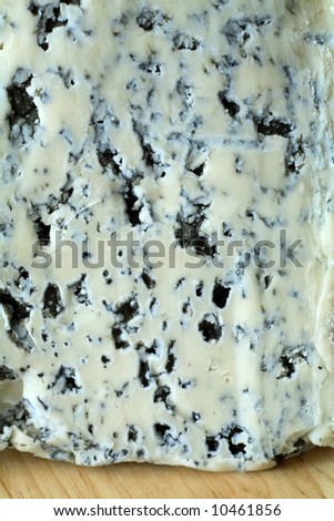 Close-up view of a Valdeon blue cheese, a gourmet delicacy from northern Spain on a wooden board.