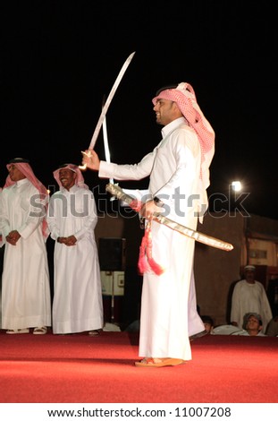 Members of a Qatari folk troupe performing the traditional Bedouin sword dance, the Arda, during Doha Cultural Week, 2008