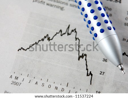 A newspaper share price chart showing a crumbling stock price, with a ballpoint pen on it.