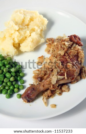 Chicken leg coated with sliced almonds in the French country style, served with peas and potato.