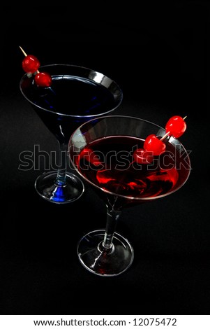 Two cocktails, one red one blue against a black backgound.