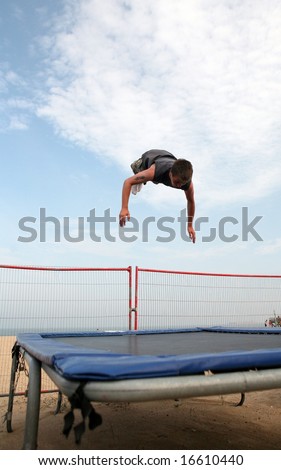 A youth trampolining on the beach at Great Yarmouth, Norfolk, England