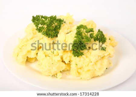 A serving plate of creamed parsley potatoes on a plain background.
