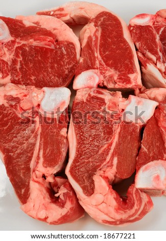 A plate of lamb loin chops, seen close-up