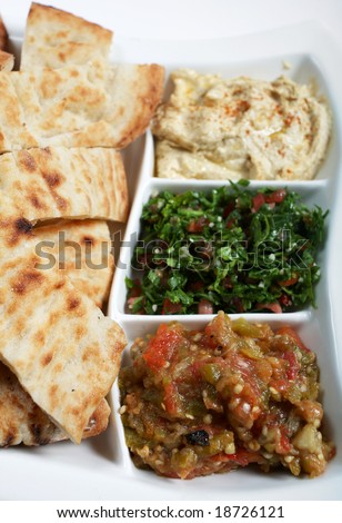 Traditional Arab or Mediterranean mezze with Turkish flat bread. From the front: babaganoush, tabouleh and hummus