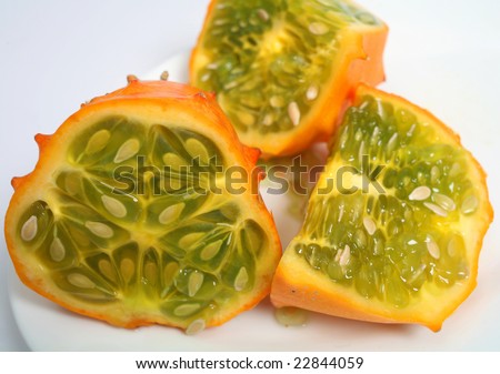 An African horned cucumber or horned melon cut in pieces on a plate