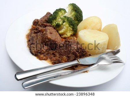 A warming plate of beef stew with boiled potatoes and broccoli
