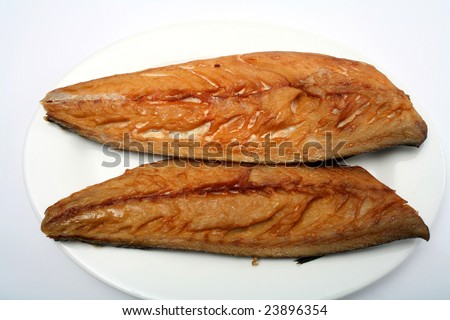 Two smoked mackerel fillets on a plate with a white background