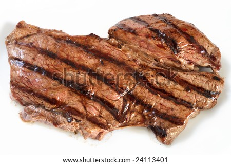 A grilled rump steak on a white plate