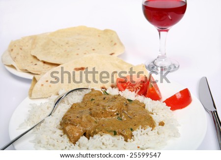 Chicken korma, boiled rice and tomato with a glass of wine.