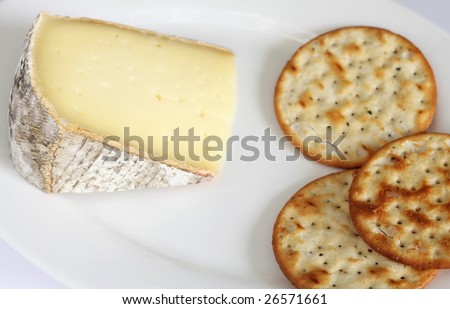A wedge of French low fat Tomme de Savote cheese with biscuits