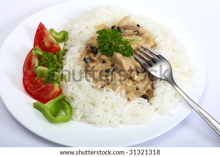 Left-over chunks of roast turkey cooked up in a mushroom and cream sauce and served with white rice and a salad