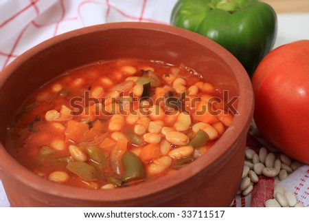 A healthy vegetarian meal of white bean soup, made with dried white beans, tomatoes, celery, onions, carrots, capsicum and olive oil. This is a significant part of the Mediterranean diet.